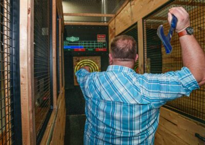 Man playing axe throwing at wedding reception