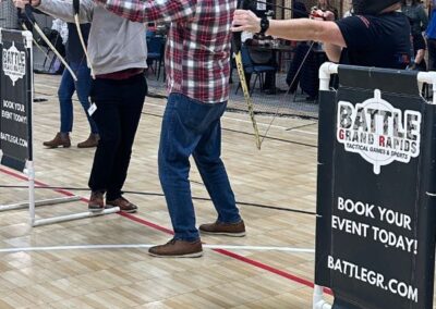 Adult social event with 3 men playing archery tag