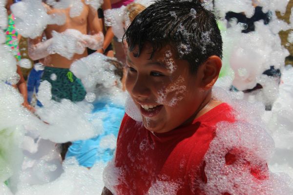 Boy laughing at bubble pit