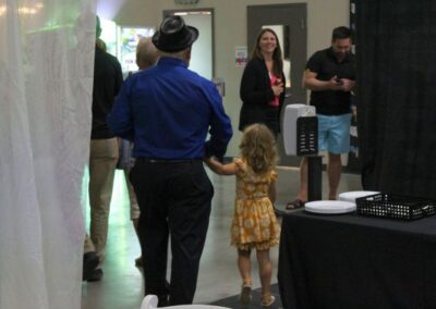 Man walking away with young child towards a woman