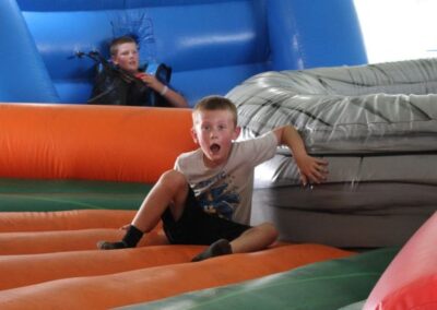 School event small boy having fun on inflatable