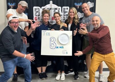 Team members with sign at corporate teambuilding event