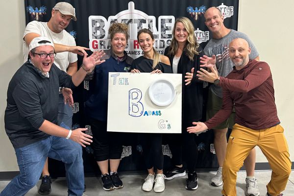 Team members with sign at corporate teambuilding event