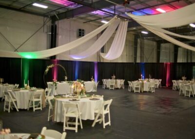 event center setup with tables and streamers