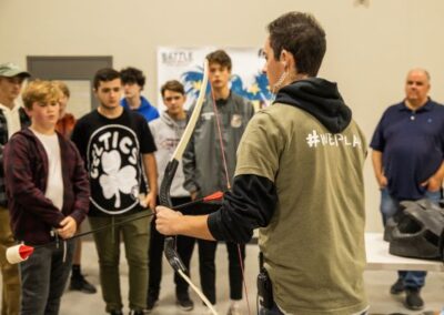 team leader explaining archery tag to students at the grand rapids school event venue