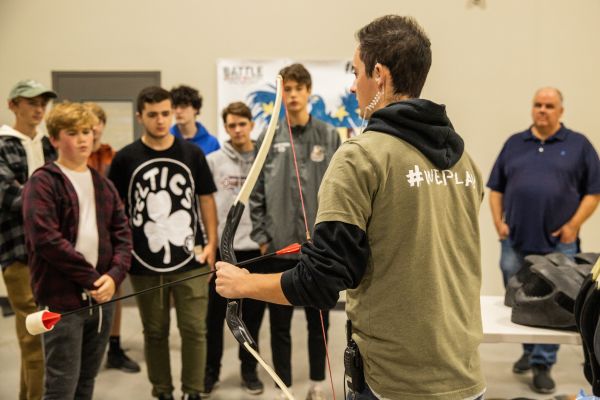 team leader explaining archery tag to students at the grand rapids school event venue