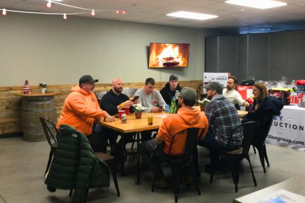 team of workers sitting at table working on teamwork